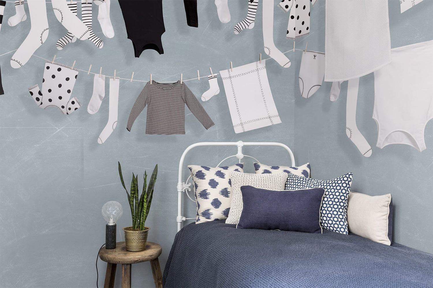 Playful blue mural wallpaper with laundry line illustration