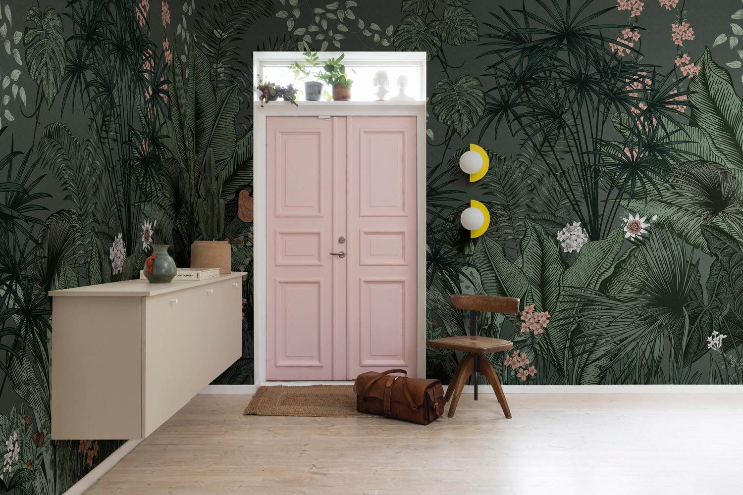 Dark tropical wallpaper mural with bold foliage in an entryway