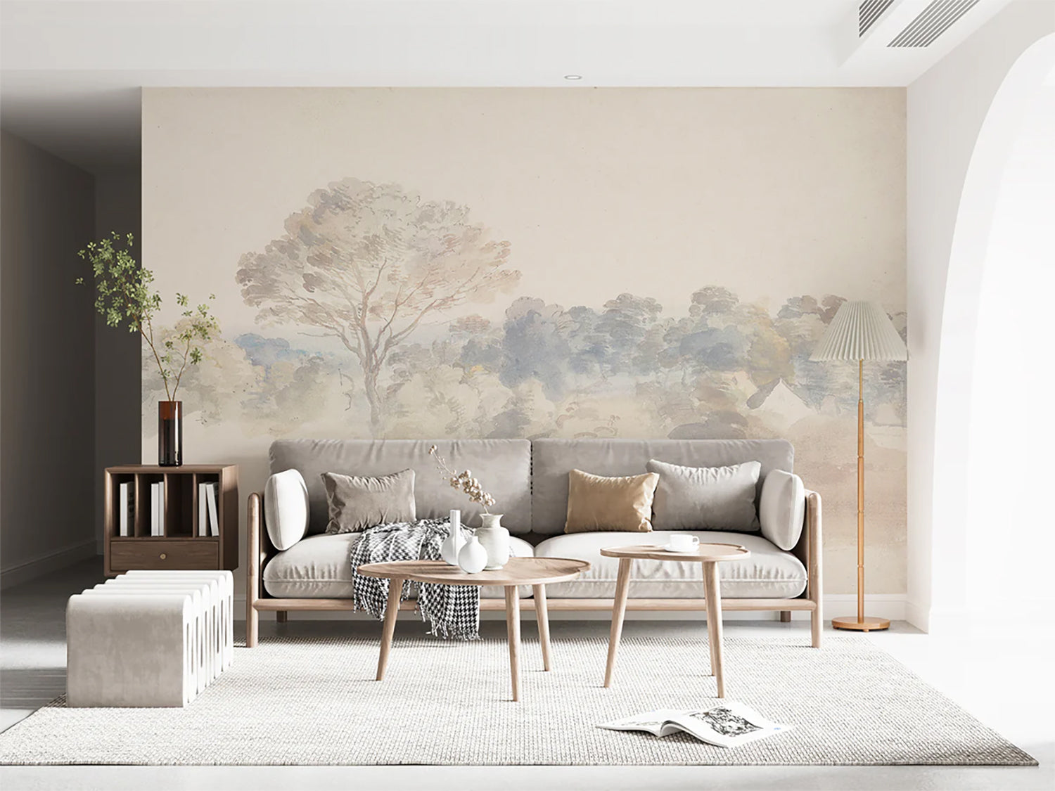 Beige nature mural wallpaper featuring soft watercolour trees in a modern living room with neutral sofa, wooden furniture, and minimalist décor