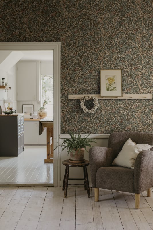 Dark wallpaper with intricate rowan berry branches layered with delicate leaves against dark charcoal background