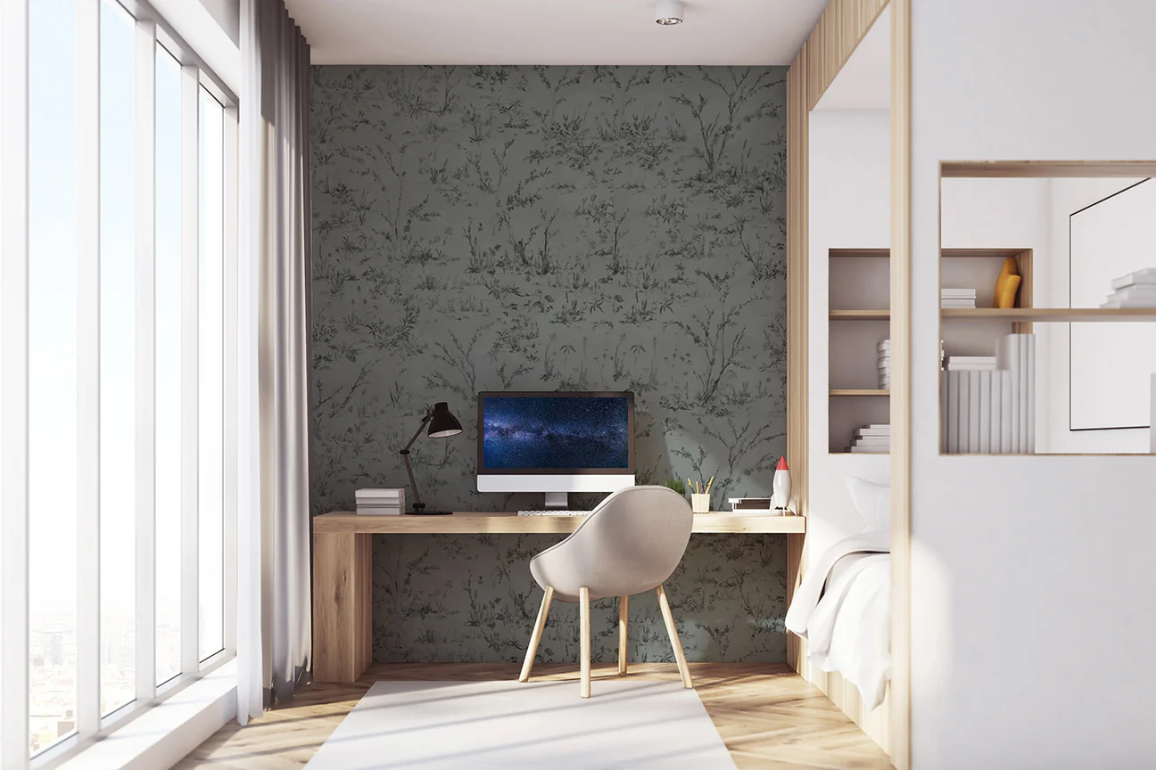 Home office with Trisha, Floral Pattern Wallpaper in the background and work desk in front. there is a laptop on the desk