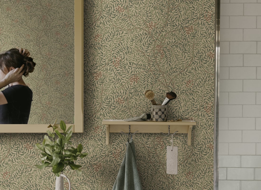 Green botanical wallpaper with leafy pattern in a welcoming entryway