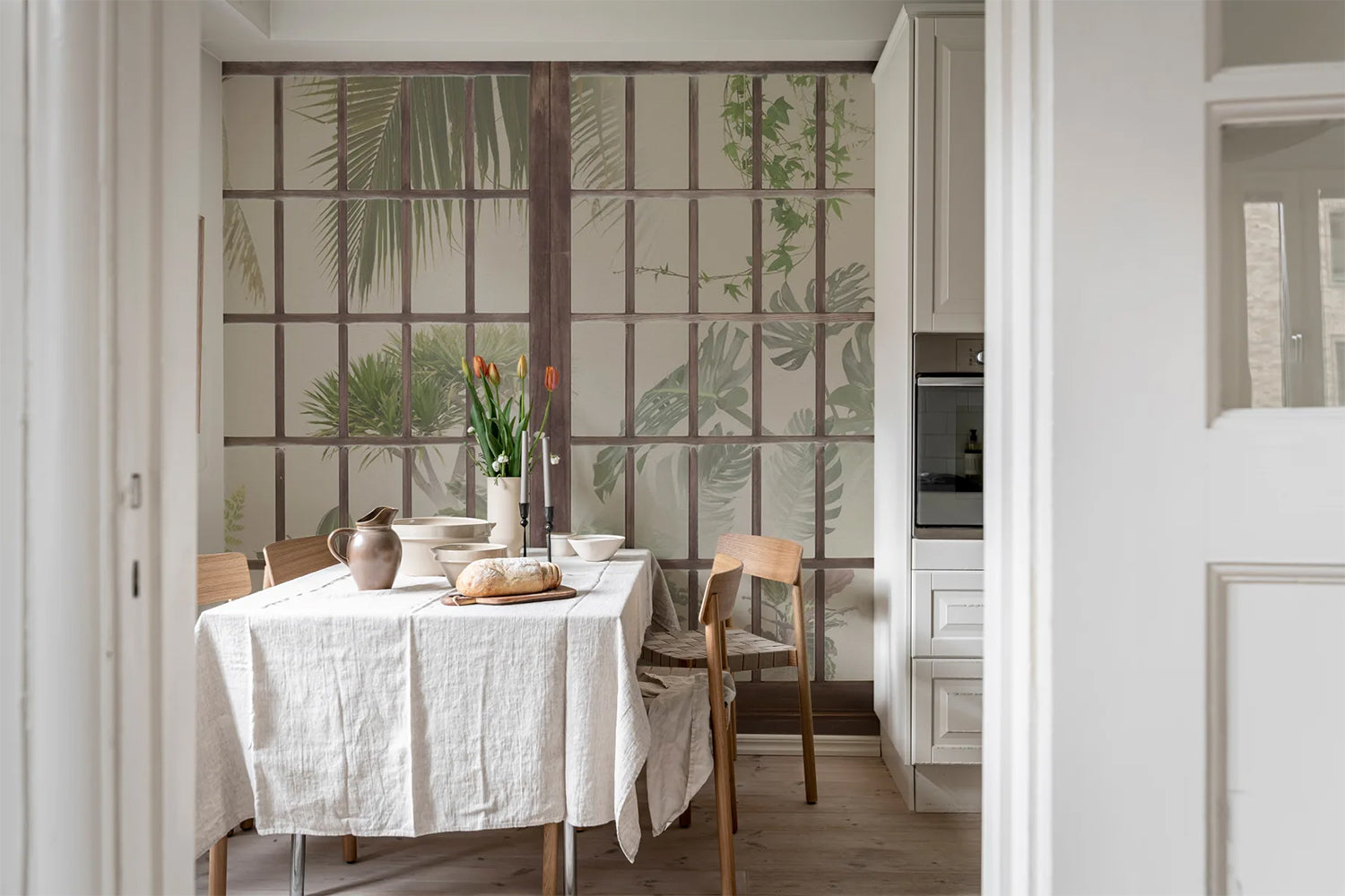 Window View Beige Wallpaper creating a tropical-inspired dining room setting