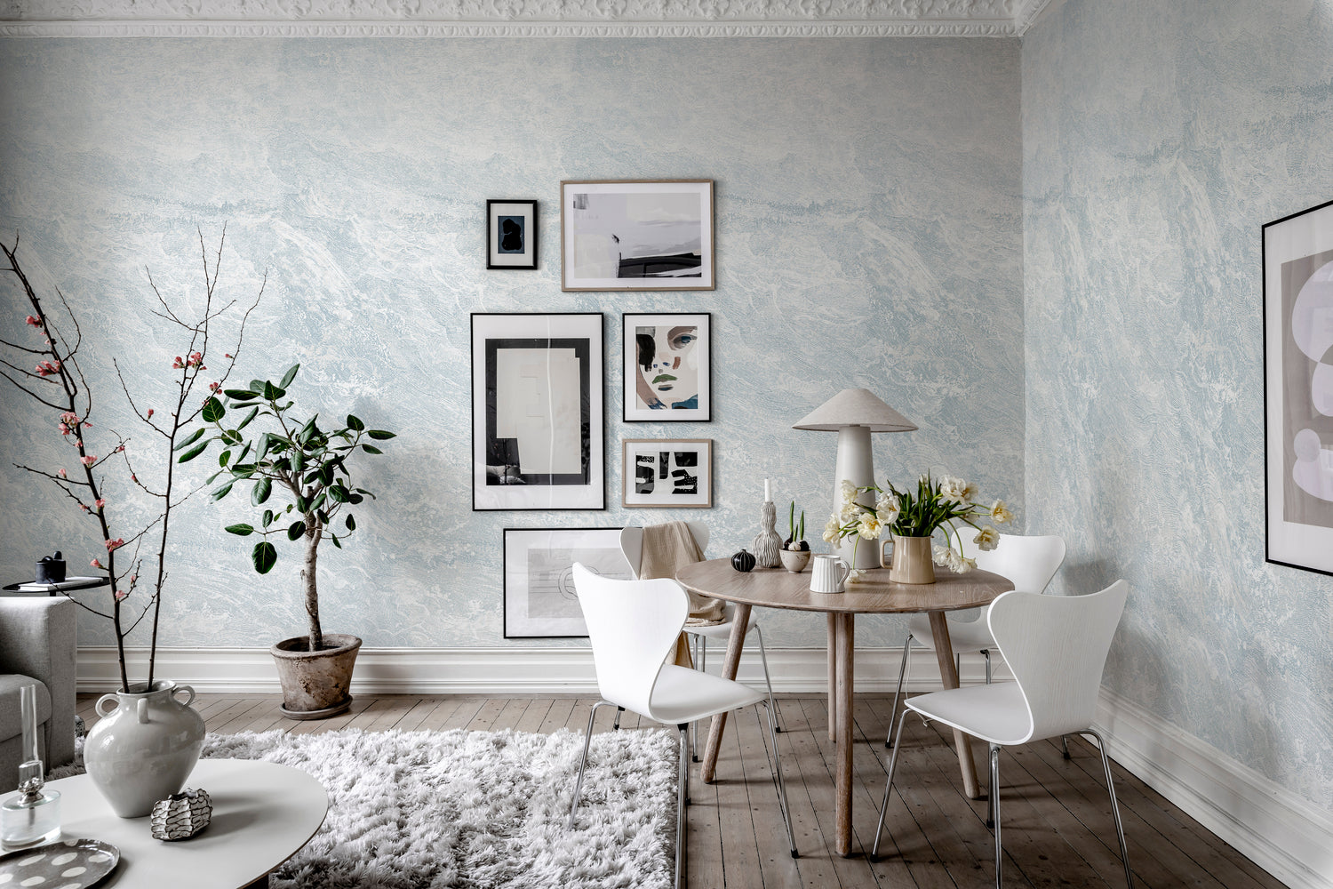Water wallpaper with calming blue wave mural design in a Scandinavian dining area