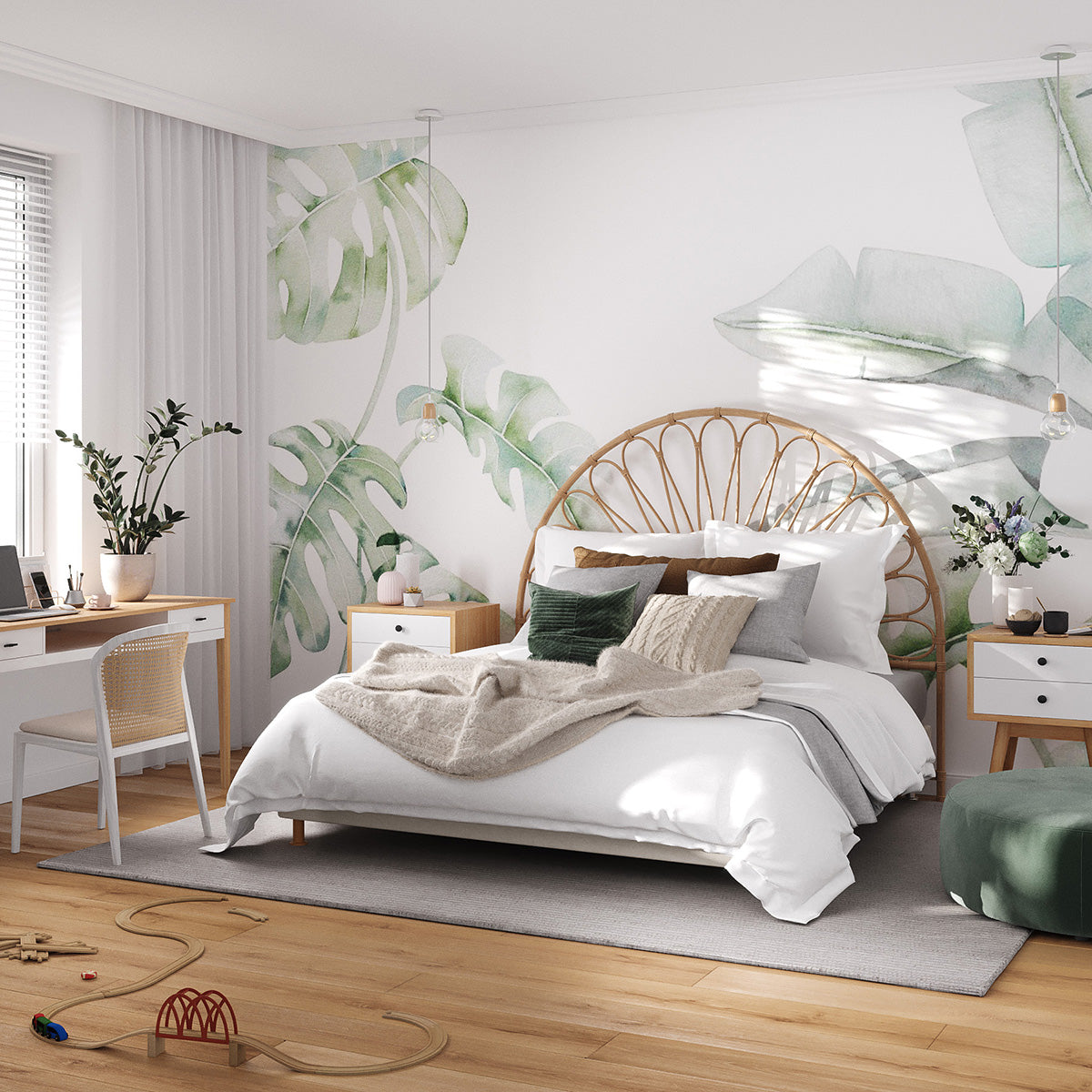 Garden Bloom rainforest wallpaper with soft watercolour monstera and tropical leaves behind a bed with a rattan headboard and white bedding