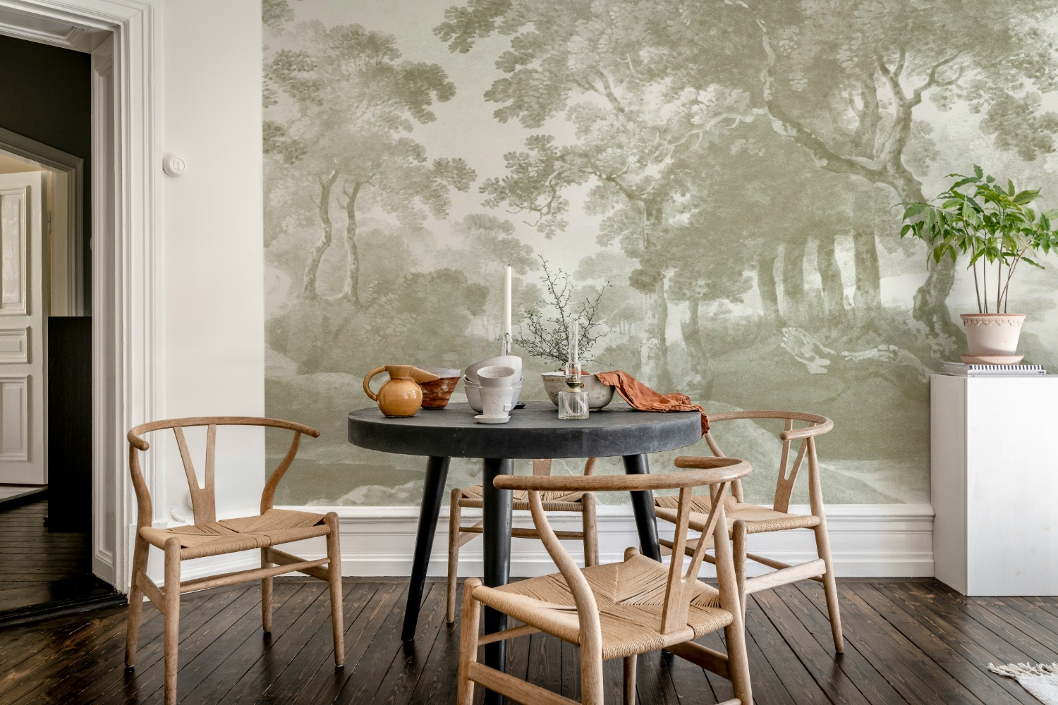 Vintage Grove Forest Mural Wallpaper in Dining Room with Wooden Chairs and Black Dining Table