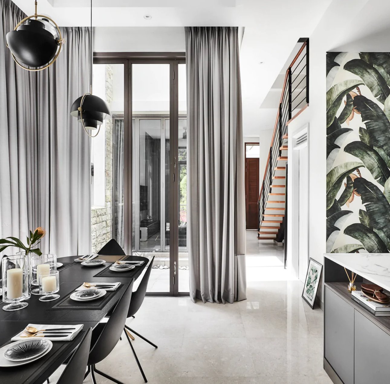 Banana Leaves Wallpaper in a living room near kitchen featuring a dining table