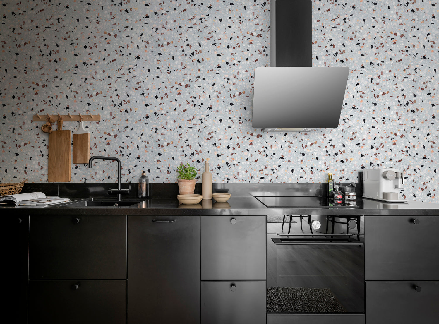 Terrazzo Kern small pattern wallpaper with subtle terrazzo chips on greyish-blue background