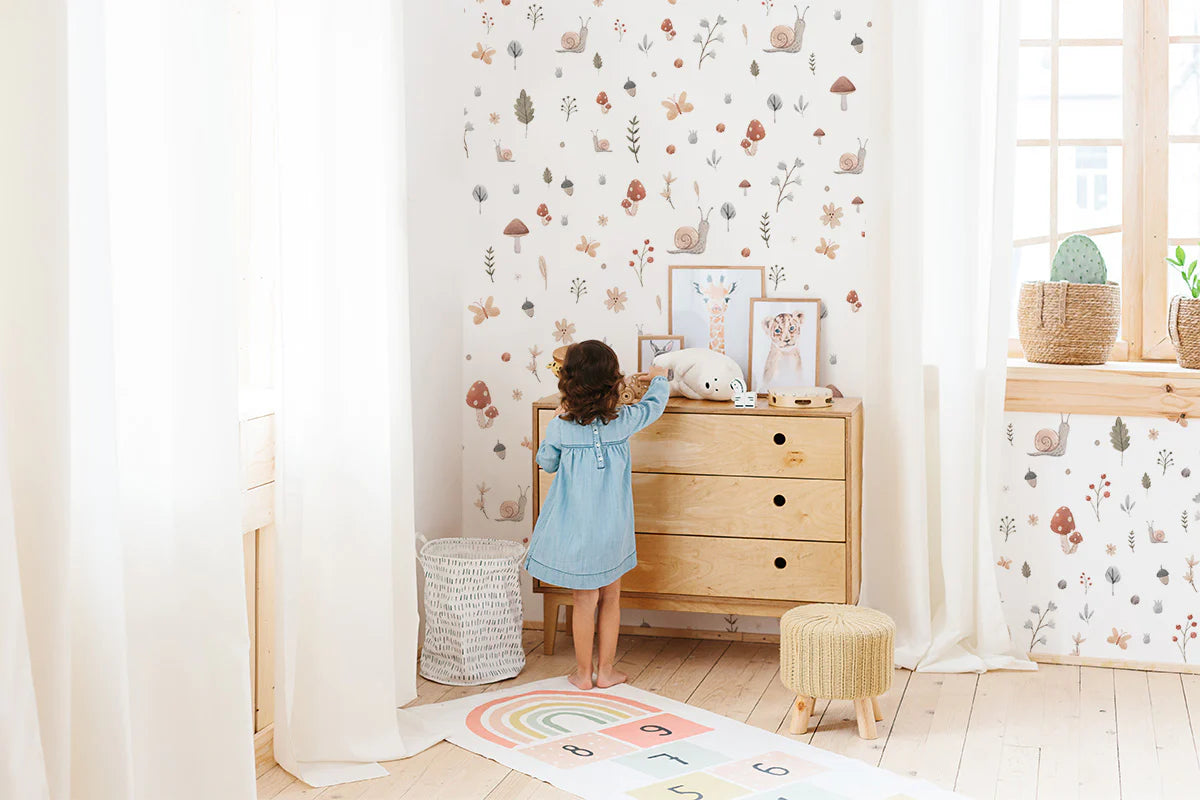 Baby girl wallpaper with illustrations of mushrooms, foliage, and little garden friends design
