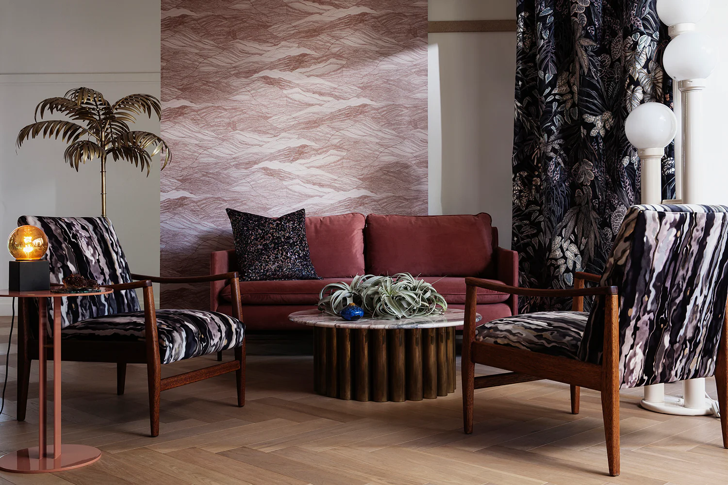 Tidal Waves Wallpaper in Terracotta graces a living area where it is complemented by black curtains and a stylish black foamed wooden chair, resulting in a bold and sophisticated interior