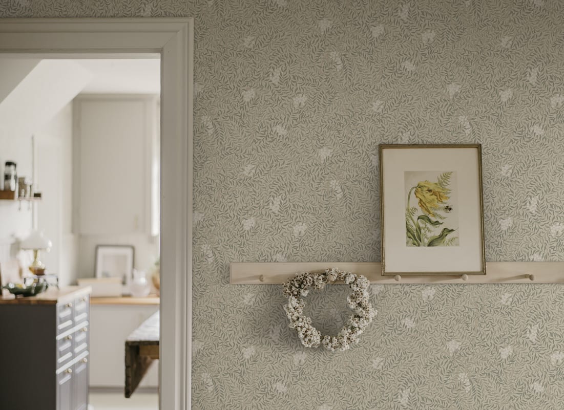 Vintage botanical wallpaper in sand colour featured in hallway with leafy heritage pattern